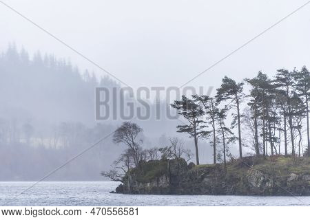 Beautiful Calm Peaceful Winter Landscape Over Thirlmere In Lake District With Fog And Layers Of Tree