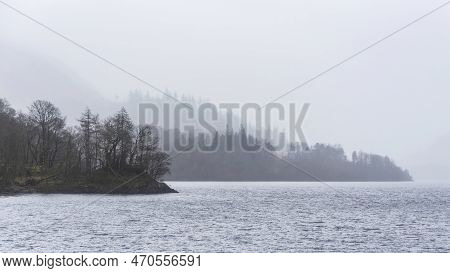 Beautiful Calm Peaceful Winter Landscape Over Thirlmere In Lake District With Fog And Layers Of Tree