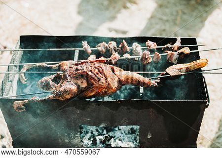 Whole Duck Barbeque In A Charcoal Grill