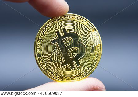 Finger Hold Bitcoin Golden On Black Isolated. Hand Hold Gold Bitcoin Crypto Ditital Money Concept. O