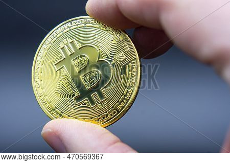 Finger Hold Bitcoin Golden On Black Isolated. Hand Hold Gold Bitcoin Crypto Ditital Money Concept. O
