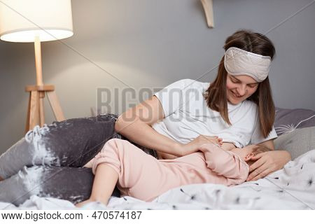 Indoor Shot Of Young Beautiful Mother, Breastfeeding Her Newborn Baby Girl In The Morning, Woman In 