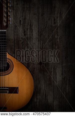 String Instrument Named Bandurria, On Aged Wooden Background And Photographed In Low Key