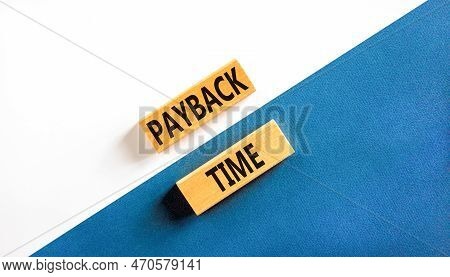 Payback Time Symbol. Concept Words Payback Time On Wooden Blocks. Beautiful White And Blue Backgroun