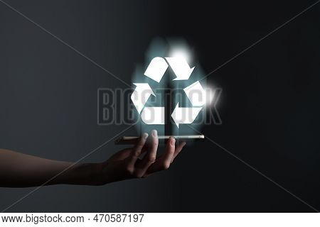 Hand Holding Recycle Symbol On A Screen Of Mobile Phone. Mobile Applications As Asource Of Informati