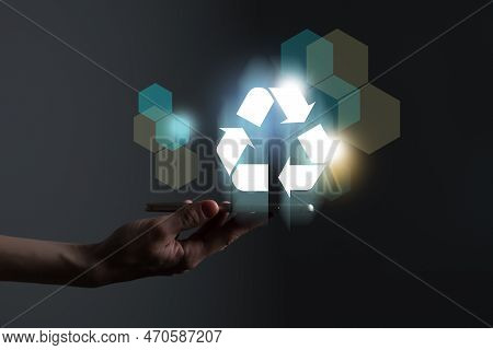 Hand Holding Recycle Symbol On A Screen Of Mobile Phone. Mobile Applications As Asource Of Informati