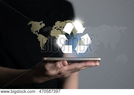 Hand Holding Recycle Symbol On A Screen Of Mobile Phone. Mobile Applications As Asource Of Informati