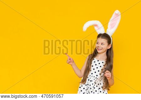 A Cheerful Girl With Rabbit Ears On Her Head And Chicken Eggs In Her Hands On A Yellow Background. P