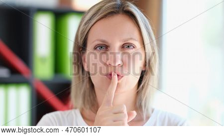Adult Woman Holds Finger On Her Lips And Gestures To Be Silent And Keep Secret. Conspiracy, Secrets 