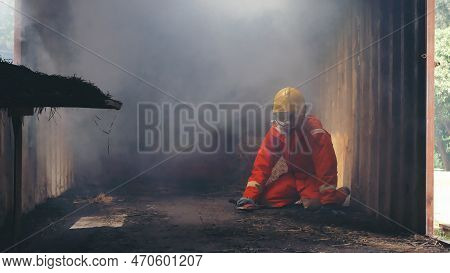 Firefighter Rescue Training In Fire Fighting Extinguisher. Firefighter Fighting With Flame Using Fir