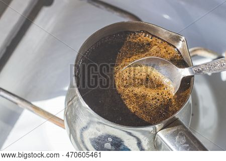 Barista Preparing Hot Tasty Drink From Copper Turk, Boils Water For Coffee On Small Fire In Cezve. C