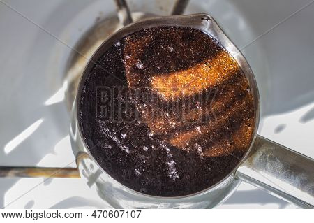 Barista Preparing Hot Tasty Drink From Copper Turk, Boils Water For Coffee On Small Fire In Cezve. C