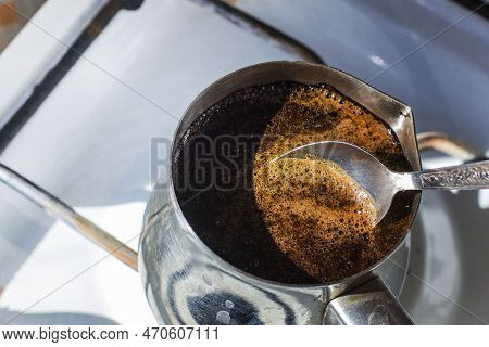 Barista Preparing Hot Tasty Drink From Copper Turk, Boils Water For Coffee On Small Fire In Cezve. C