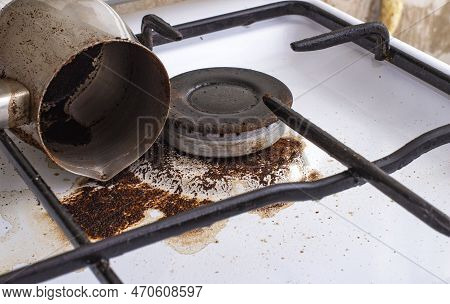 Dirty Gas Stove With Spilled Coffee From Cezve, Front And Background Blurred With Bokeh Effect