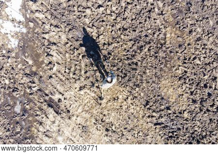 Man On A Treasure Hunt With A Metal Detector In The Woods On The Field, Photographed From A Drone, B