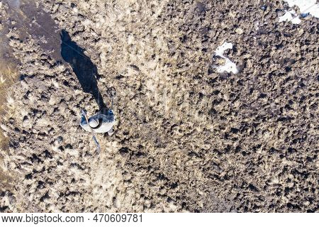 Man On A Treasure Hunt With A Metal Detector In The Woods On The Field, Photographed From A Drone, B