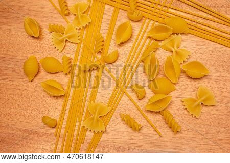 Top View Various Types Of Italian Pasta On Wooden Background