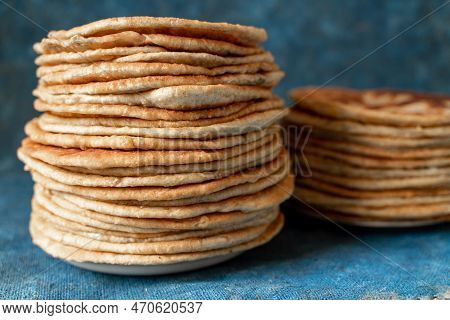 Flatbread Lavash, Chapati, Naan, Heap Of Tortilla On A Blue Background Homemade Flatbread Stacked.
