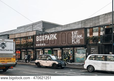 London, Uk - February 09, 2023: Taxi In Front Of Shops At Boxpark Shoreditch, London, Shipping Conta