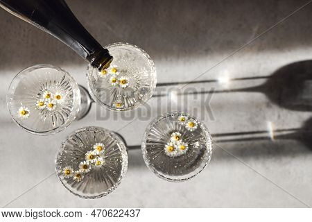 Champagne Pourig Into Glasses On A Light Table Surface Reflecting Soft Sunshine Rayson. Sparkling Wi