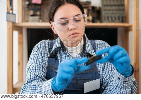 Engineer Repairs Laptop Support Fixing Notebook Computer. It Woman Installs Equipment Cpu, Ram, Ddr3