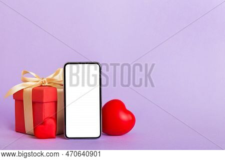 Mobile Phone With Blank Screen On Colored Background With Hearts, Calendar And Gift Box, Valentine D