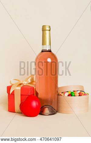 Bottle Of Wine On Colored Background For Valentine Day With Gift Box. Heart Shaped With Presrnt Box 
