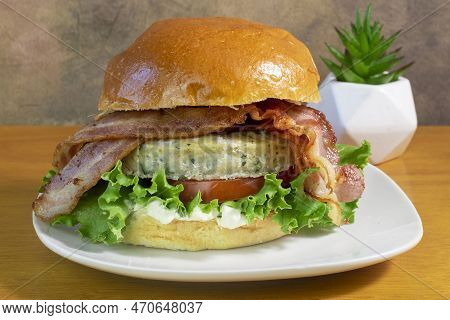Chicken Burger Top With Hickory Bacon Between A Brioche Bun