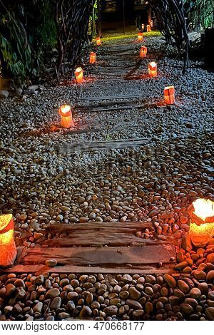 Decoration With Candlelight On A Charming And Romantic Stone Path With Pieces Of Rustic Wood In A Su