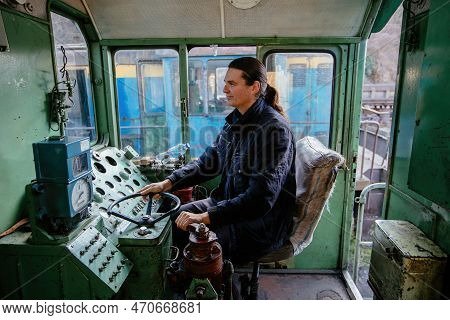 Engine Train Driver Inside Of Locomotive Control Room.