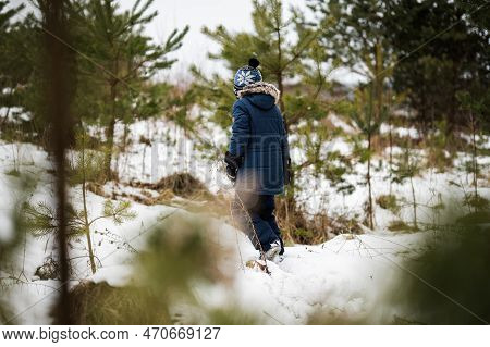 Boy Walking In Winter Forest Alone. Pam Pam Pam