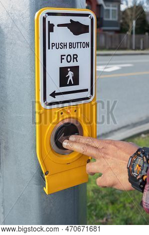 Hand Pressing A Button At Traffic Lights On Pedestrian Crossing. Pushing Button For Traffic Light. B