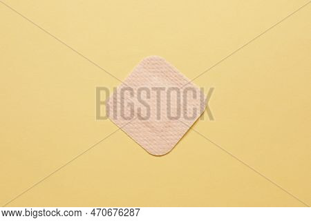 Contraceptive Patch On Yellow Background, Top View