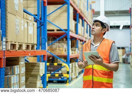 Asian Man Business Owner Using Checklist Recheck Amount Of Stock Product Inventory On Shelf At Distr