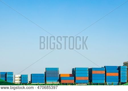 A Large Cargo Container Ship Loaded With Containers Against The Blue Sky And Empty Space