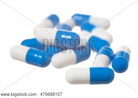 Blue Pills On White. Focus On The Front Capsule.