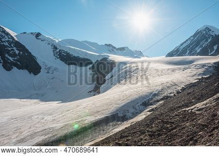 Scenic Mountain Landscape With Large Glacier In Sunlight. Awesome Scenery With Glacial Tongue In Sun