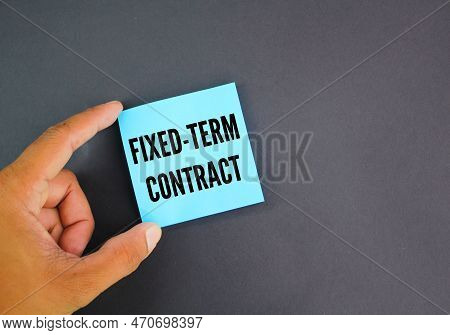 Hand Holding A Blue Paper With The Word Fixed-term Contract