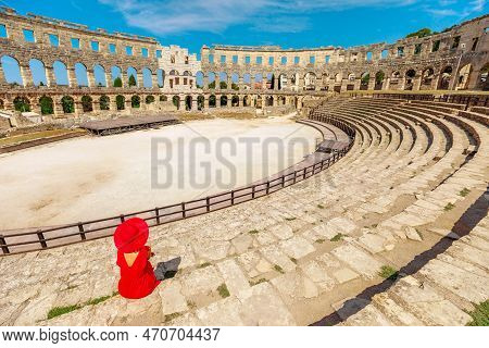 Tourist Inside Pula Amphitheater Or Coliseum Of Pula Is A Well-preserved Roman Amphitheater, Located