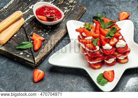 Homemade Tiramisu Cake With Fresh Strawberry, Mascarpone And Mint. Tiramisu Portion On Plate On Ligh