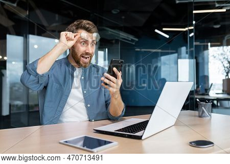 Mature Man Shocked By Bad News And Online Notification Received On Phone, Businessman At Work Frustr