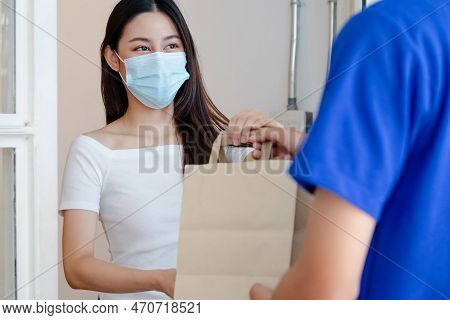 Young Asian Woman, Customer Wearing Face Mask Protect To Pandemic Of Covid And Received Bag,cardboar