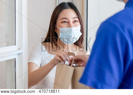Young Asian Woman, Customer Wearing Face Mask Protect To Pandemic Of Covid And Received Bag,cardboar