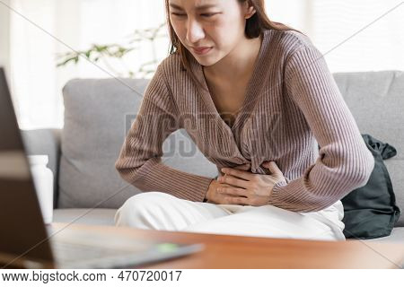 Flatulence Asian Young Woman Hand In Stomach Ache Suffer From Food Poisoning, Gastritis Or Diarrhoea