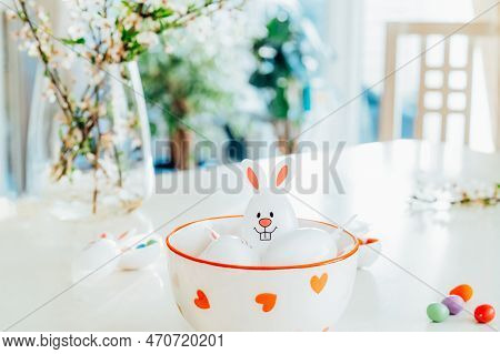 Close Up Funny Easter Eggs Containers With Bunny Ears Filled With Candy And Chocolate In A Bowl On T