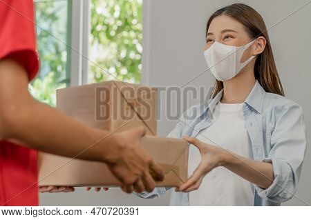 Asian Young Woman, Client Received A Delivery Of Cardboard Box, Parcel From Delivery, Postman, Weari