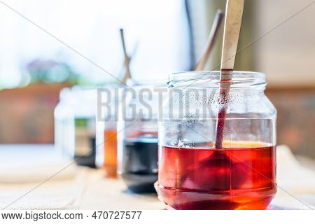 Easter Eggs Color At Home In The Kitchen With Cucumber Glasses And Various Colors, Germany