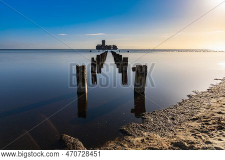 Gdynia, Poland - April 2022: Old Ruins Of Torpedo Room And Old Wooden Pier On The Baltic Sea Next To