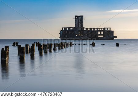 Gdynia, Poland - April 2022: Old Ruins Of Torpedo Room And Old Wooden Pier On The Baltic Sea Next To