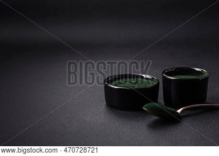 Spice, Green Color Spirulina In The Form Of Powder In A Black Bowl